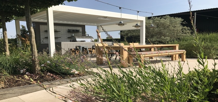White pergola over an outdoor dining area.