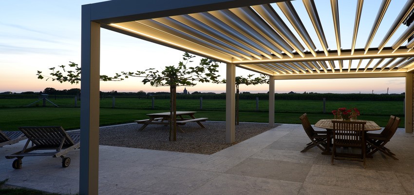 A pergola in early evening with lighting