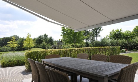 Brustor retractable awning installed over patio dining area