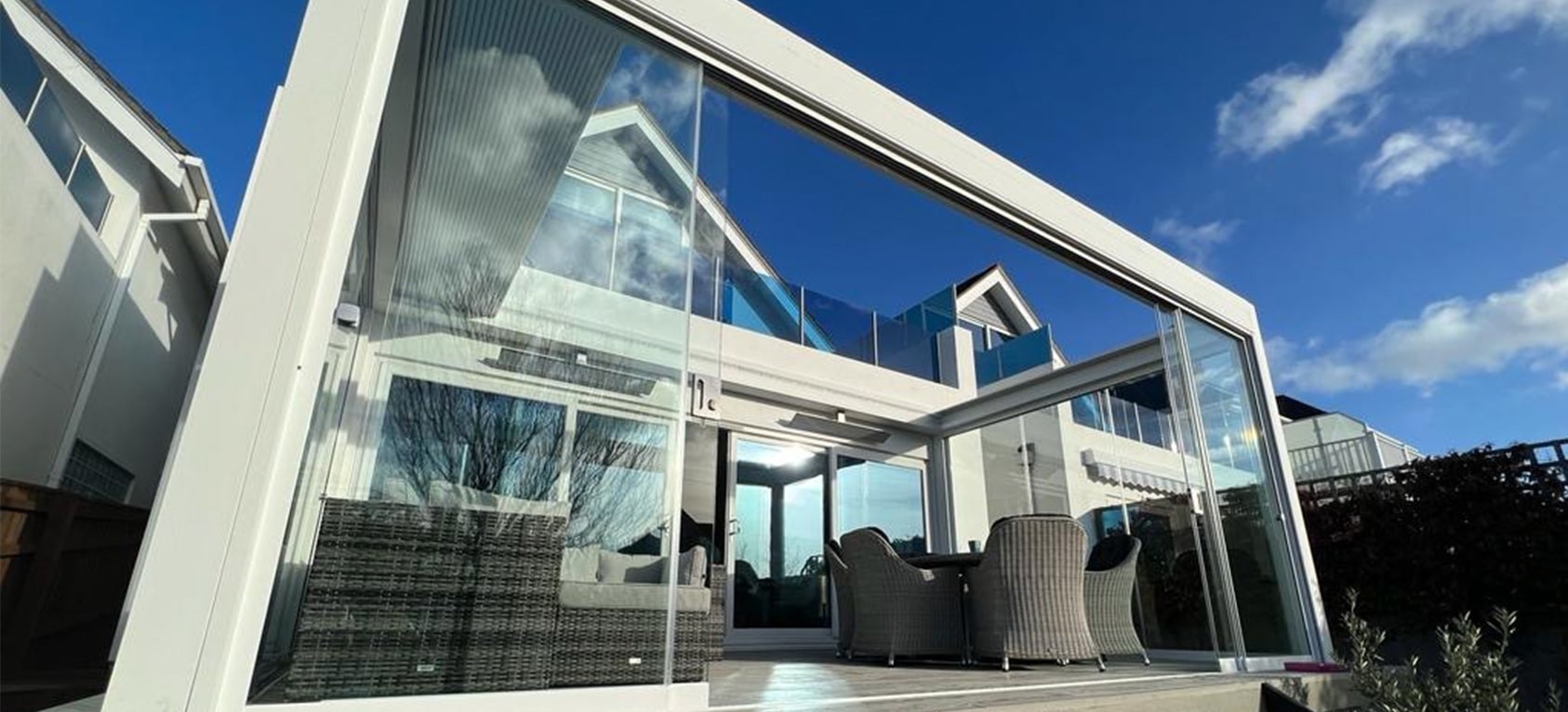 A Pergola with Glass sides and a retractable roof system