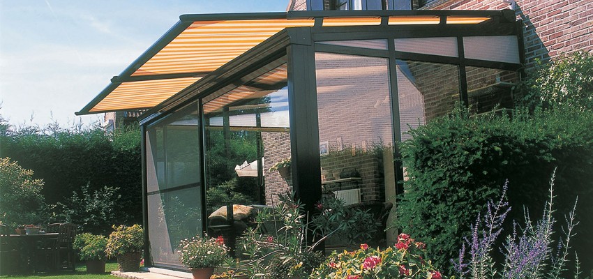 An Awning Above A Glass Roofed Conservatory to Provide Shade